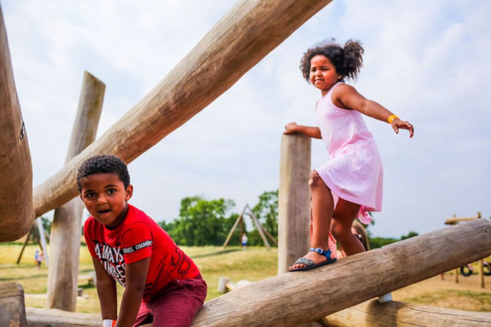 Kids climbing over logs at Williams Den
