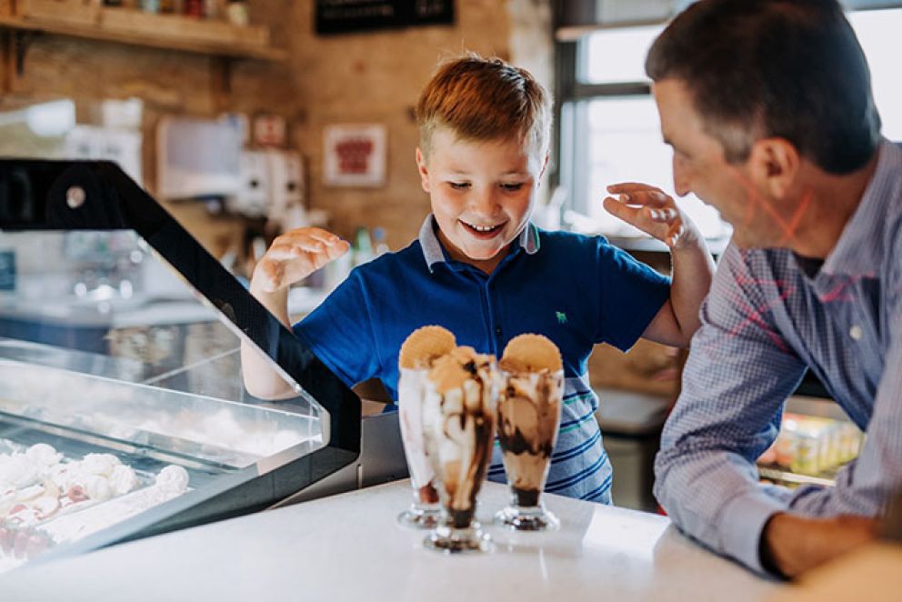 Boy and Dad eating a Super Sundae
