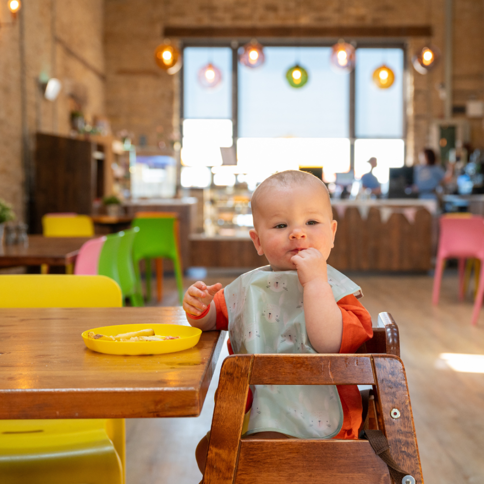 baby boy sat in highchair
