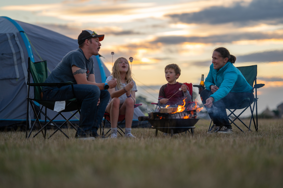 Family enjoying camping at William's Den, a family campsite in Yorkshire with spacious pitches and adventure play.