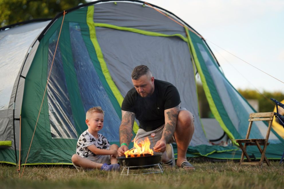 Dad and son by camp fire